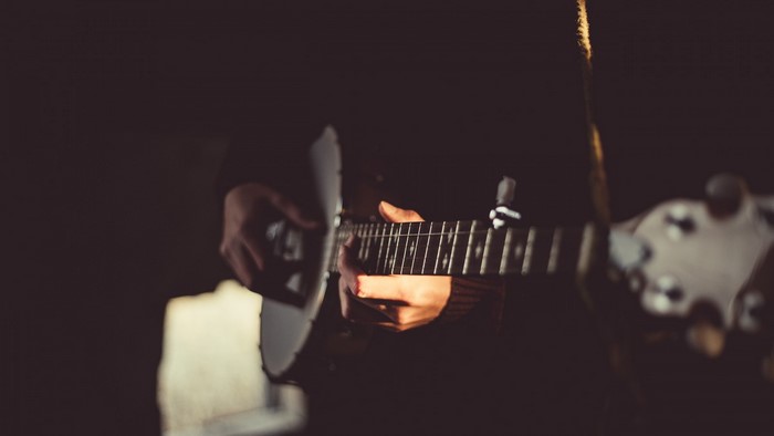 Close-up of hands playing a banjo