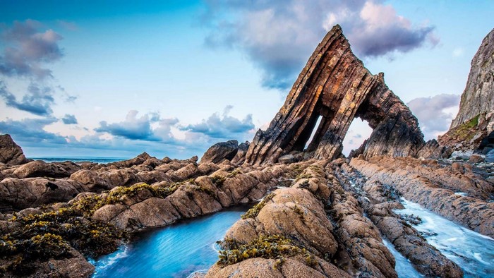 Blackchurch Rock formation on a rocky coast with the sea and clouds