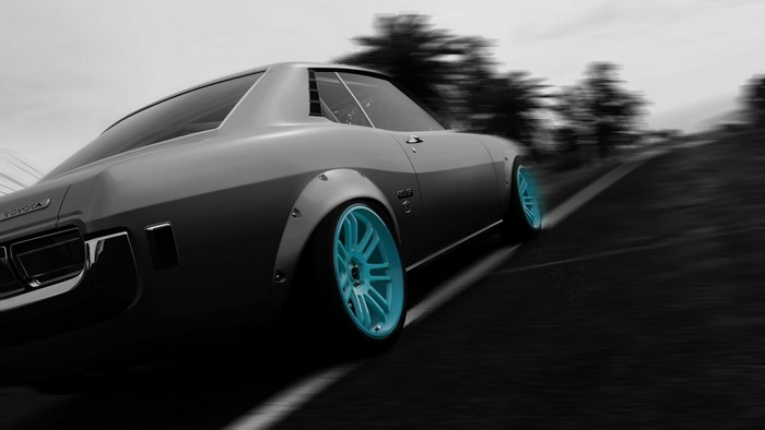 Toyota Celica with blue wheels on a road