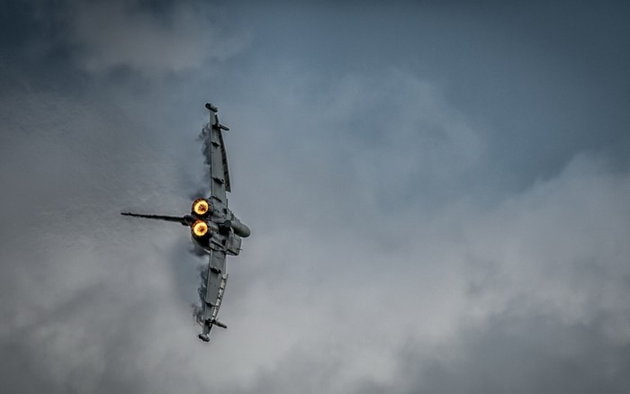 Eurofighter Typhoon performing aerobatics in cloudy sky