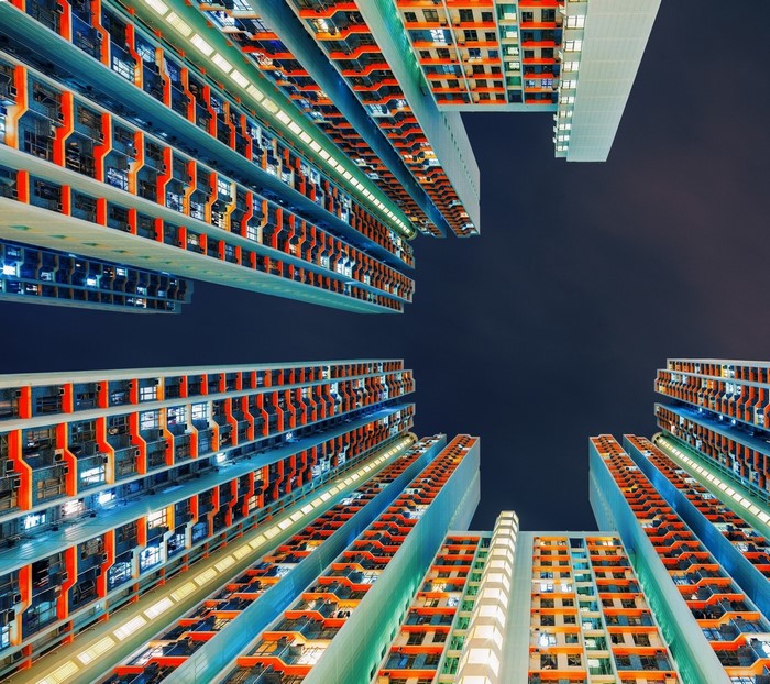 Worm's eye view of colorful apartment buildings at night