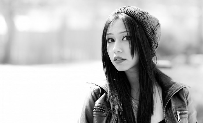 Woman wearing a knit hat and leather jacket