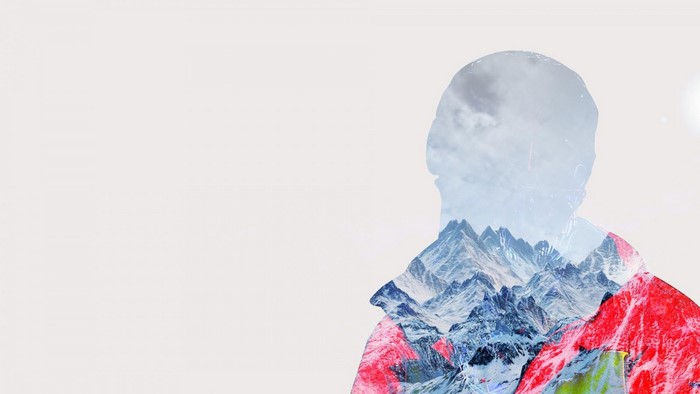 Double exposure of a person with mountains