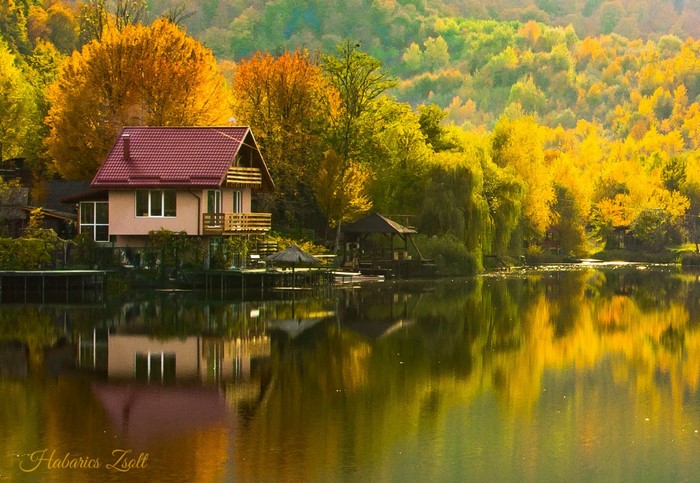 House on a lake during autumn with colorful trees