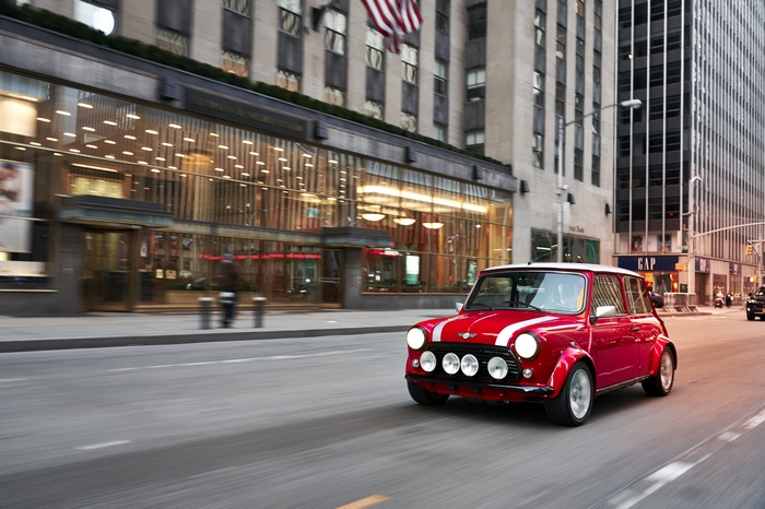 Red Mini Electric Concept driving on city street