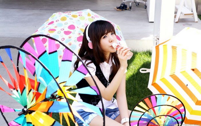 Asian girl in headphones eating ice cream