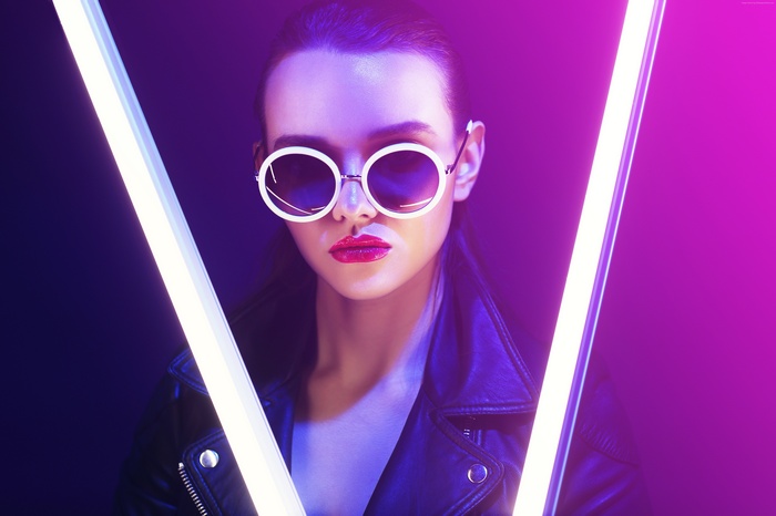 Girl in leather jacket wearing sunglasses with neon lights