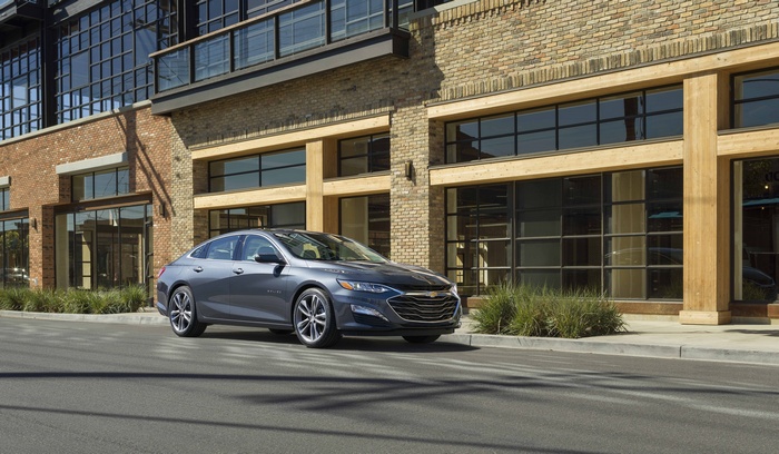 Chevrolet Malibu Electric car parked in front of a brick building