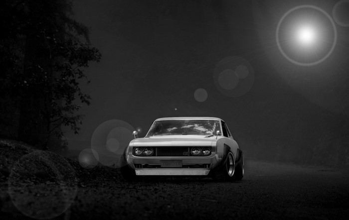Monochrome Toyota Celica GT sports car on a dark road