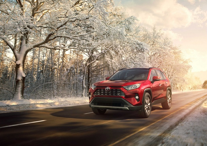 Red Toyota RAV4 SUV on a Snowy Road
