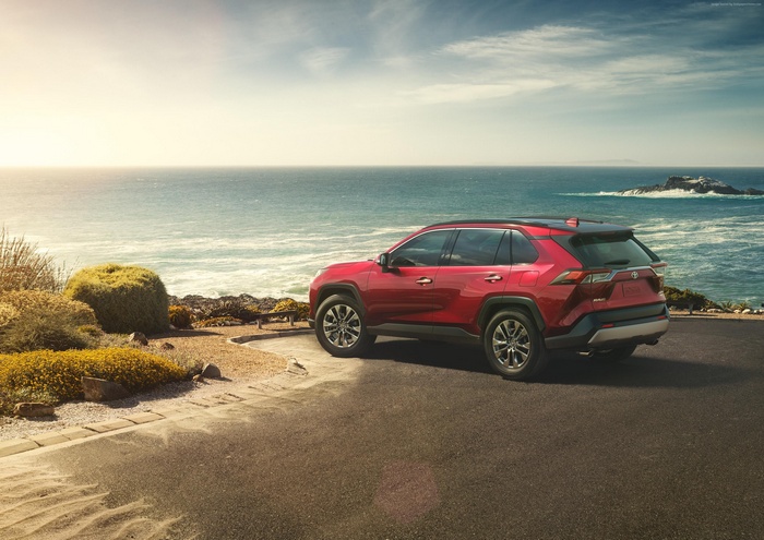 Red Toyota RAV4 parked by the ocean