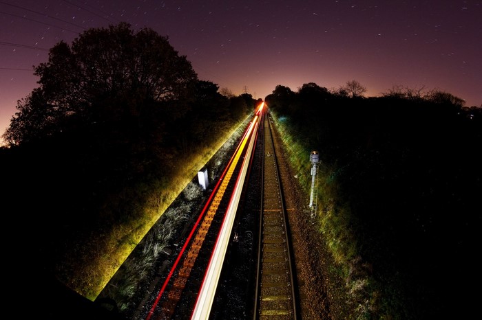 Long exposure of a train at night with light trails