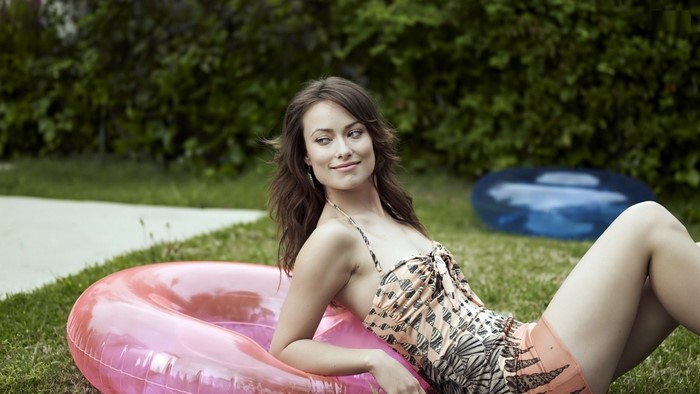 Olivia Wilde relaxing on a pink inflatable ring