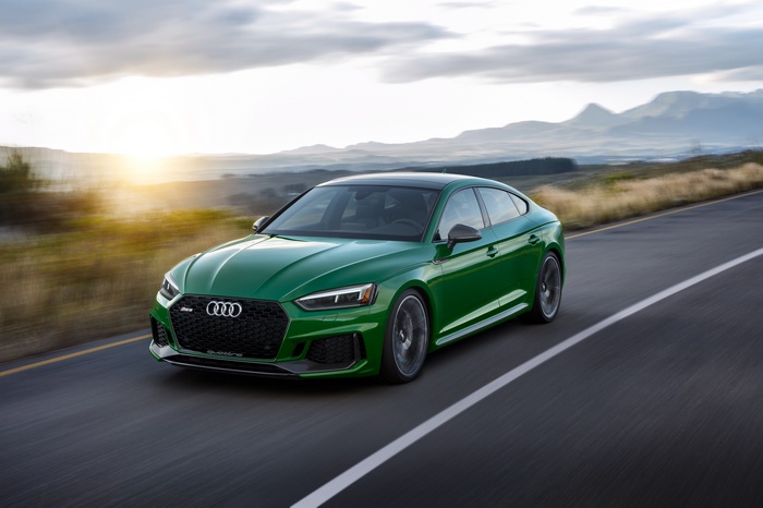 Green Audi RS5 Sportback driving on a road