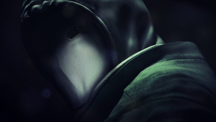 Masked figure in dark clothing