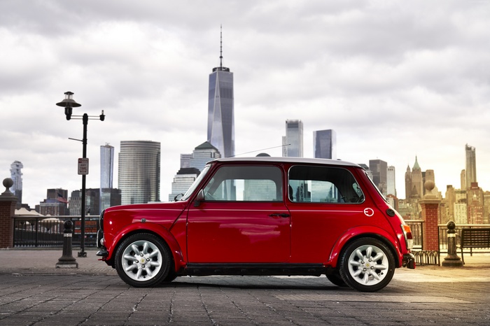 Red Mini Electric Concept car in front of New York City skyline