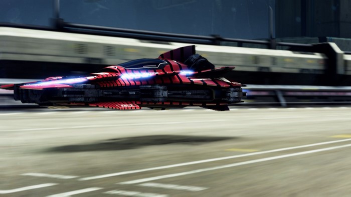 Red futuristic racing vehicle on a road