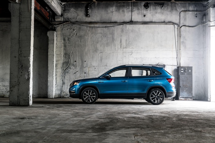 Blue Skoda Kamiq SUV in industrial setting