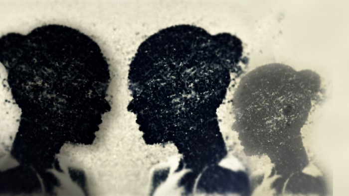 Three abstract silhouettes of women's heads