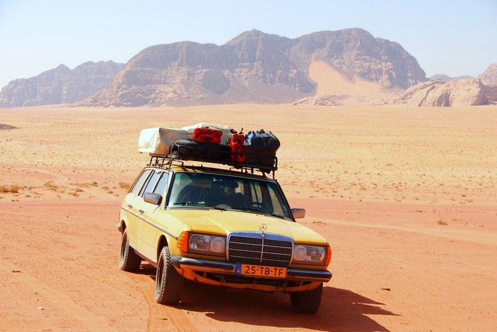 Yellow Mercedes Benz station wagon in the desert