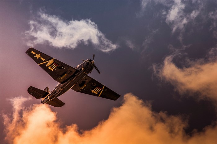 World War II airplane flying through clouds
