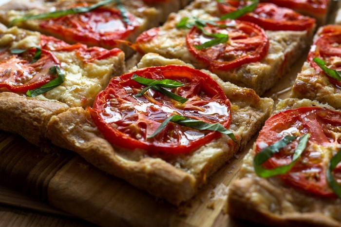 Rectangular pizza with tomatoes and basil