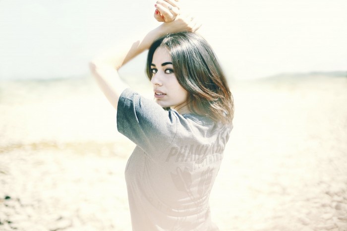 Woman with arms raised on a beach