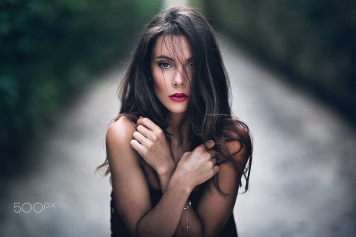 Portrait of a woman with long brown hair and red lipstick