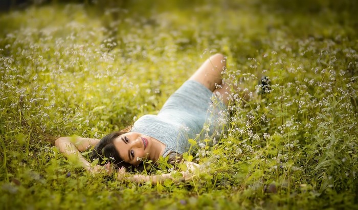 Woman lying in a field of flowers