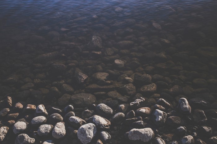 Rocks submerged in dark water