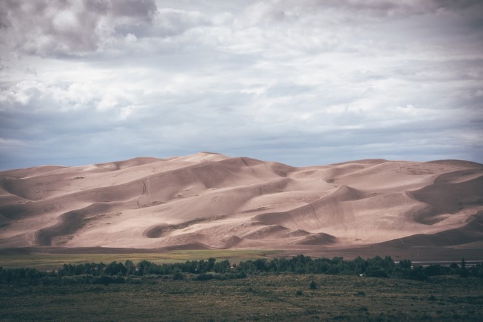 Sand dunes under a cloudy sky