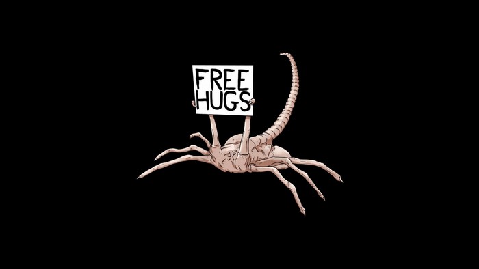 Xenomorph Facehugger holding a 'Free Hugs' sign