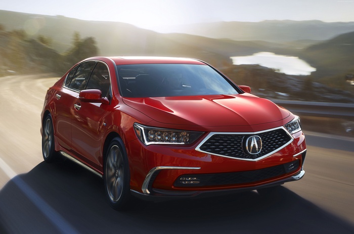 Red 2018 Acura RLX driving on a scenic road
