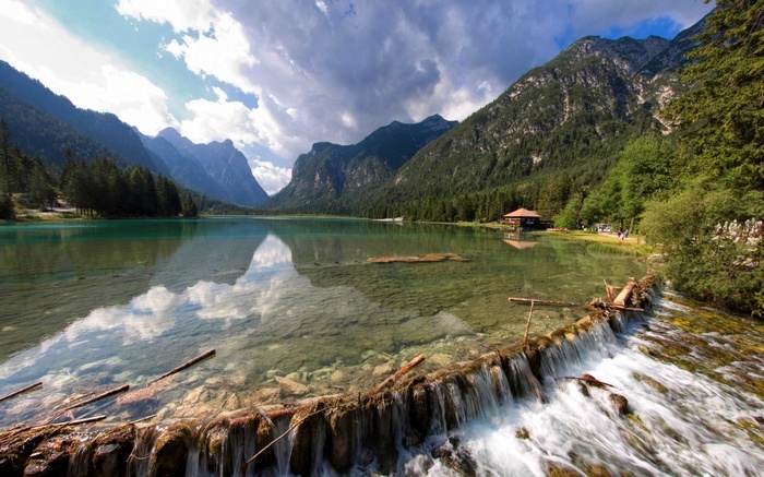 Lake with mountains and a small waterfall