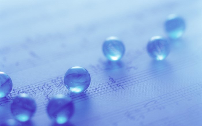 Blue glass spheres on a music sheet