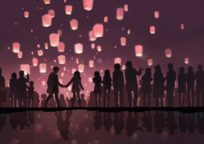 People watching sky lanterns at night
