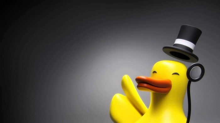 Yellow duck wearing a top hat and monocle