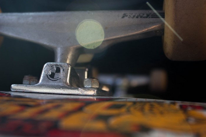 Close-up of a skateboard truck with logo