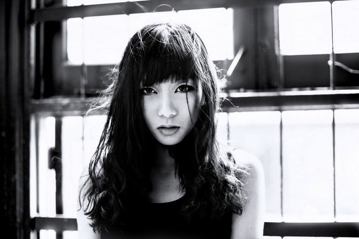 Monochrome portrait of an Asian woman with bangs