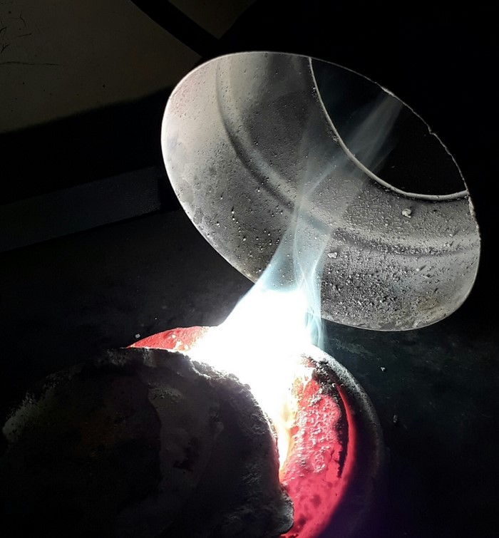 Molten metal being poured from a crucible