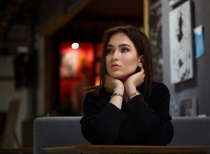Woman in black sweater sitting at a table