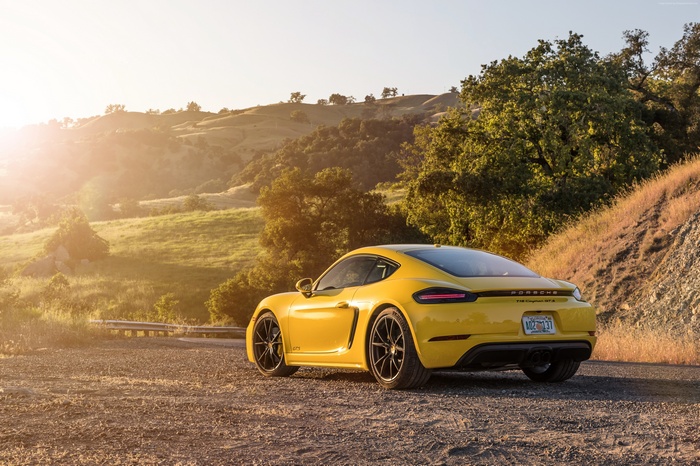 Yellow 2019 Porsche 718 Cayman GTS on a dirt road