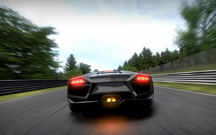 Black Lamborghini Aventador driving on a race track