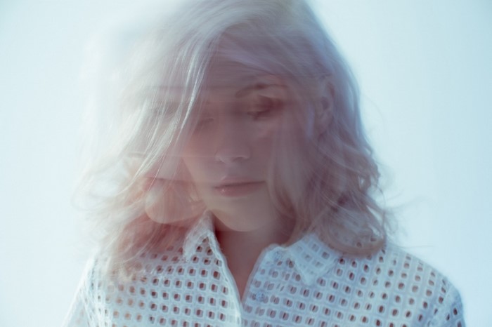 Madeline Juno portrait with blonde hair and white shirt