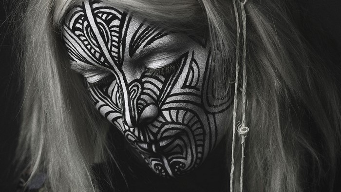 Woman with tribal face paint and white hair