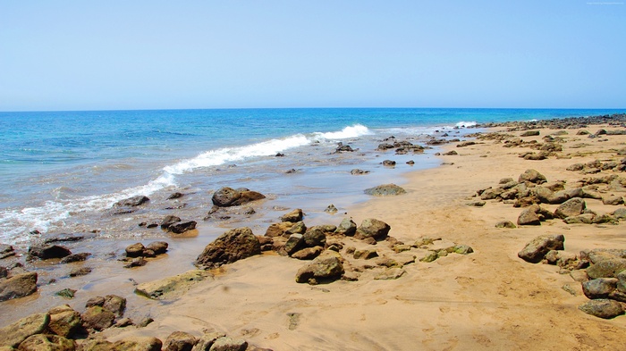 Beach with rocks and ocean waves in Lanzarote 4K