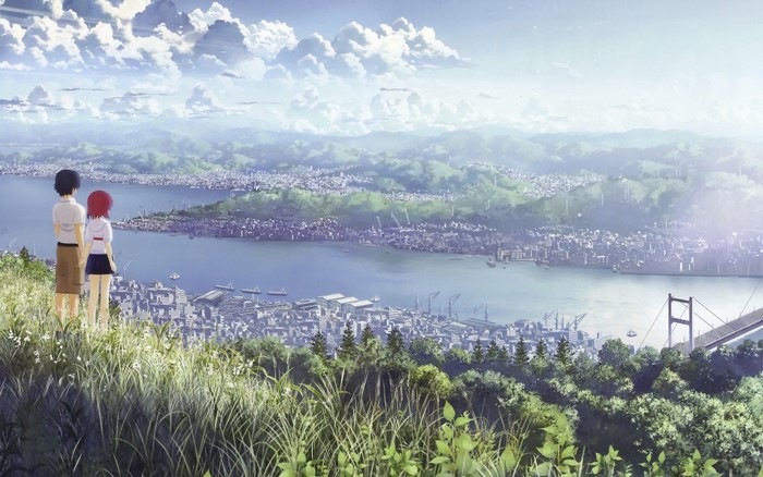 Two people overlook a vast cityscape and bay