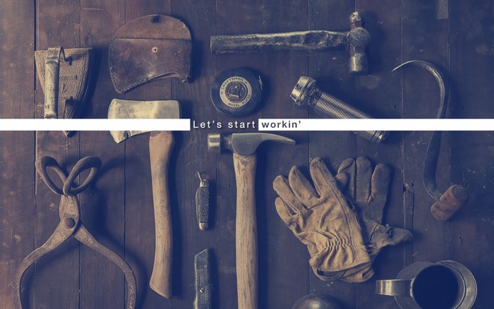 Tools on a wooden surface with text