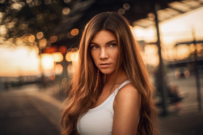 Woman with long brown hair at sunset