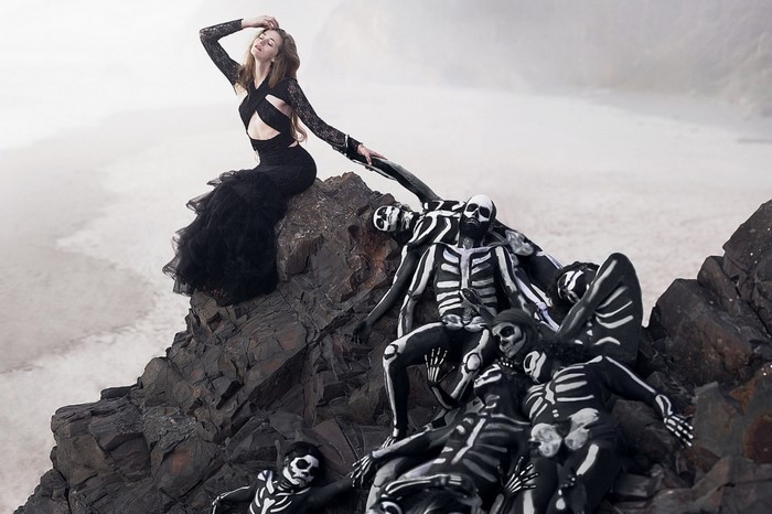 Woman in black dress with skeleton body paint models